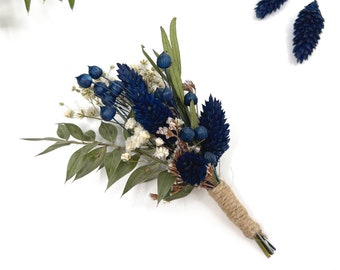 May include: A small bouquet of dried flowers in shades of blue and white, tied with twine. The bouquet includes blue thistle, blue berries, and white baby's breath.