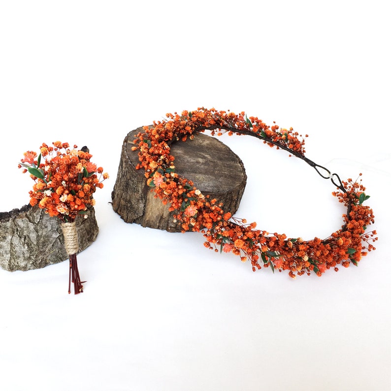 May include: A set of orange flower crowns and a matching boutonniere. The crowns are made of dried flowers and are perfect for a wedding or other special occasion.