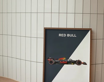 May include: A framed poster with a black and white design. The poster features a red and yellow Formula One race car with the text "Red Bull" on the side. The poster also includes the text "33 | VER 11 | PER".