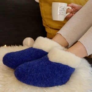 Sheep wool slippers 100% wool with leather sole. nice and warm and airy. Blue with white collar