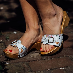 Wooden sandals with cheerful flowers