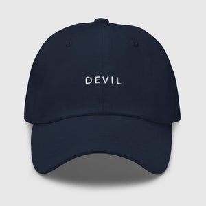 Pu&ograve; includere: Un cappello da baseball blu navy con la parola "DEVIL" ricamata in bianco sul davanti.