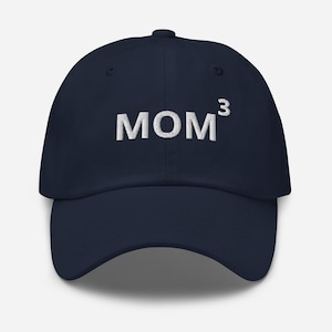 May include: A navy blue baseball cap with white embroidered text that reads "MOM³".