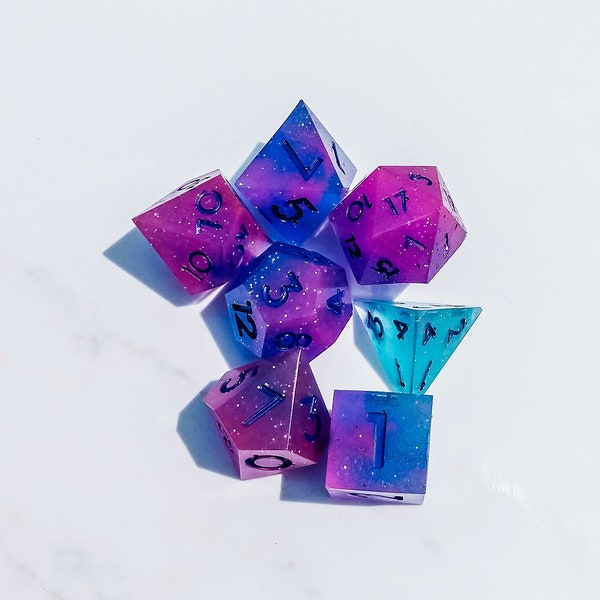 Pink purple blue galaxy nebula glow in the dark dice set. Hand polished shiny starry night sky 7-piece dice set. Ships with velvet dice bag.