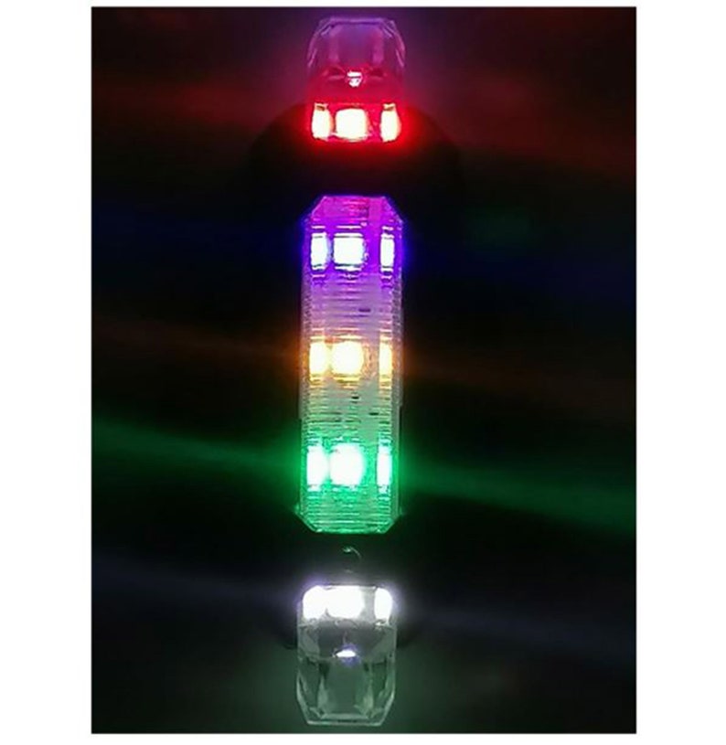 May include: Vertical image of three illuminated, clear, faceted light fixtures. The top fixture glows red, the middle one multi-colored, and the bottom one white. The background is dark, emphasizing the vibrant colors of the lights.