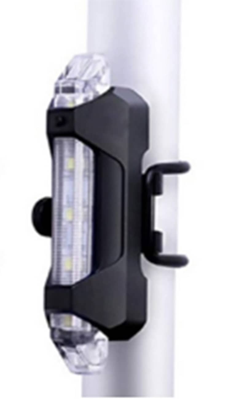 May include: Black bicycle light with a clear, rectangular lens and a black mounting bracket. The light has a series of small, bright LED lights. The light is attached to a silver pole.