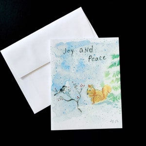 Tarjeta navideña de alegría y paz: tarjeta de felicitación con acuarela pintada a mano y un bosque nevado