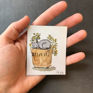 花の中の猫の冷蔵庫マグネット | 水彩画のお昼寝の絵