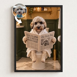 May include: A framed wall art print featuring a light-coloured curly-haired dog wearing a white bathrobe, sitting on a toilet and reading a newspaper titled The Daily Dog with the headline DOG CLAIMS HE'S NEVER BEEN FED! A small circular inset shows the dog's face.