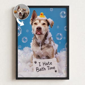 May include: A framed print featuring a brown and white dog covered in white soap bubbles against a blue background. A small yellow rubber duck sits on the dog's head. A white sign in front reads I Hate Bath Time with paw prints.