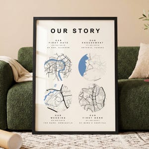 May include: A framed print with the text "OUR STORY". The print displays four circular map illustrations with dates and locations: first date, engagement, wedding, and first born. The maps are in black and white with blue accents.