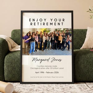 May include: A framed print with the text "ENJOY YOUR RETIREMENT" above a group photo. Below the photo, the text reads "Margaret Jones" and details of her retirement from April 1996 to February 2026. The print is in a black frame.