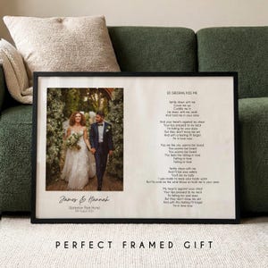 May include: A black framed print with a wedding photo of a couple, with the names "James & Hannah" and wedding date below. The print includes song lyrics from "Kiss Me" by Ed Sheeran. The words "PERFECT FRAMED GIFT" are at the bottom.