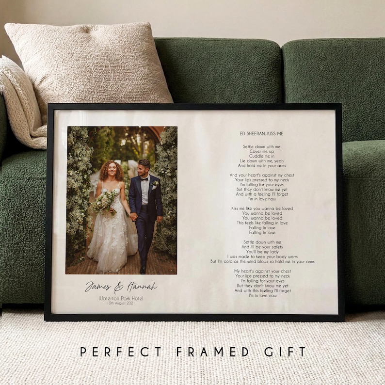 May include: A black framed print with a wedding photo of a couple, with the names "James & Hannah" and wedding date below. The print includes song lyrics from "Kiss Me" by Ed Sheeran. The words "PERFECT FRAMED GIFT" are at the bottom.