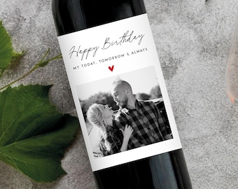 May include: A dark glass wine bottle with a white rectangular label featuring the black text Happy Birthday and MY TODAY, TOMORROW & ALWAYS, a small red heart icon, and a black and white photograph of two people looking at each other.