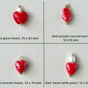 May include: Four red heart charms with gold accents. The charms are made of glass and ceramic. The charms are different sizes and shapes. The charms are perfect for jewelry making.