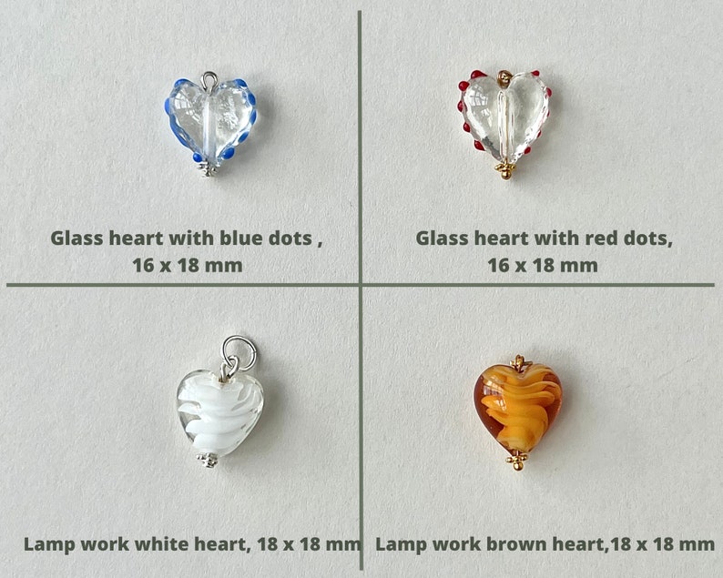 May include: Four glass heart charms with different designs and colors.  The top left charm is clear glass with blue dots, the top right charm is clear glass with red dots, the bottom left charm is white glass with a swirl design, and the bottom right charm is brown glass with a swirl design.  All charms are 16 x 18 mm or 18 x 18 mm.