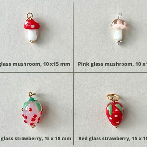 Handmade  lamp work mushroom and strawberry charms.