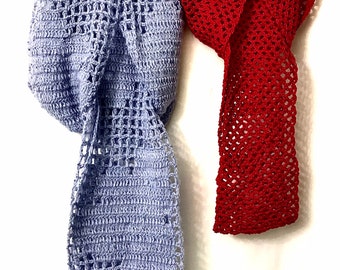 May include: Two crocheted scarves, one light blue and one red, hanging on a hanger. Both scarves have a lacy, openwork design.