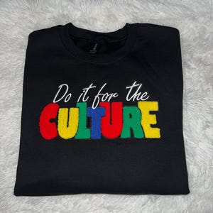May include: Black sweatshirt with the text "Do it for the CULTURE" in colorful embroidered letters.