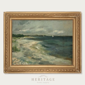 May include: A framed seascape painting depicting a sandy beach with a shoreline and a body of water with sailboats in the distance. The painting is in a gold frame with a decorative border.