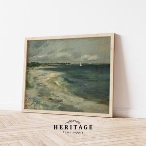 May include: A framed painting of a seascape with a sandy beach, blue water, and a cloudy sky. Two sailboats are visible in the distance.