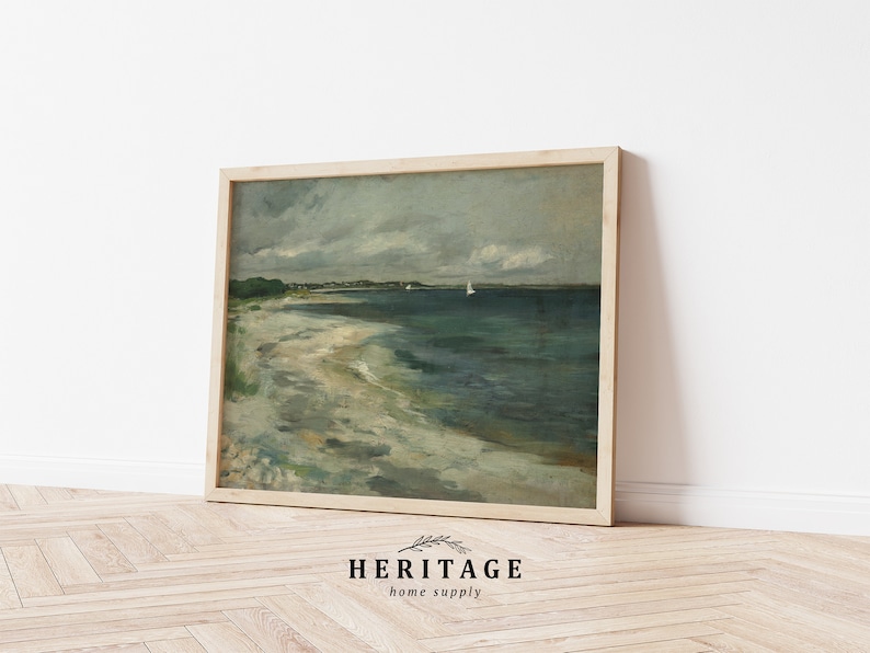 May include: A framed painting of a seascape with a sandy beach, blue water, and a cloudy sky. Two sailboats are visible in the distance.