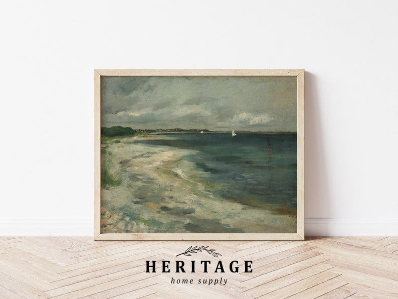 May include: A framed painting of a seascape with a sandy beach, a calm ocean, and a cloudy sky. Two sailboats are visible in the distance.