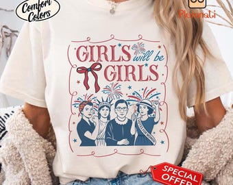 May include: Cream-colored t-shirt with the text "GIRLS will be GIRLS" in a red, stylized font. The design includes illustrations of women, fireworks, and a bow. The shirt also features the "Comfort Colors" logo and a "SPECIAL OFFER" tag.