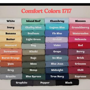 a collection of various colored t-shirts, each with a different color and pattern, arranged in a grid-like pattern.