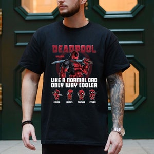May include: Black t-shirt with a Deadpool graphic and the text "Deadpool William Like a normal dad only way cooler" with four smaller Deadpool figures below with the names Emma, James, Sophia, and Ethan.