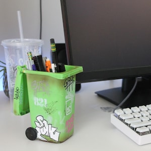 Graffitied recycling / trash bin pencil holder