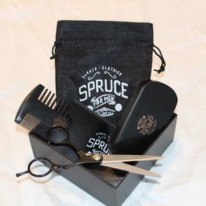 May include: A black box with a black comb, scissors, and a black brush. The box has a black and white label that says "Spruce for Men".