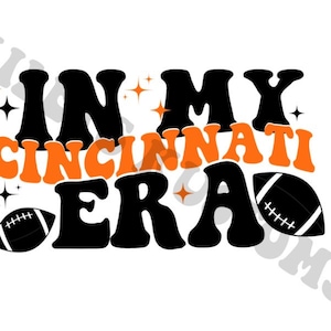 May include: Black and orange graphic with the text "In My Cincinnati Era" with two black and white footballs.
