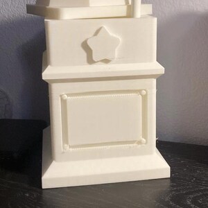 May include: White 3D printed box with a star on the front and a blank rectangular space. The box has a removable lid with a geometric design.