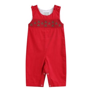 May include: Red baby romper with green embroidered holly leaves across the chest. The sleeveless romper has button closures on the shoulders and legs. The garment is made of a soft, corduroy-like fabric.