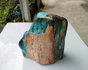May include: A large, irregularly shaped piece of wood with a blue, green, and brown colour scheme. The wood has a natural, rustic look and is polished to a smooth finish.