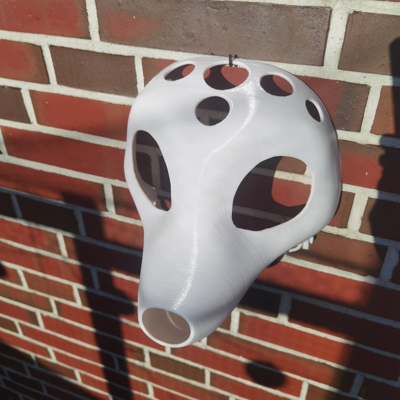 May include: White plastic mask with multiple holes, resembling a skull or animal face.
