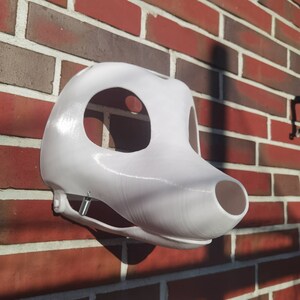 May include: White unfinished furry animal mask with a large nose and eye holes. The mask is made of a smooth, hard plastic and is ready to be painted.