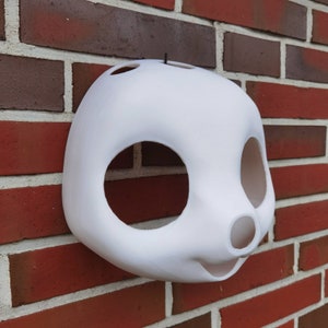 May include: White unfinished mask with large eye and nose holes. The mask is made of a smooth, hard material and is ready to be painted.