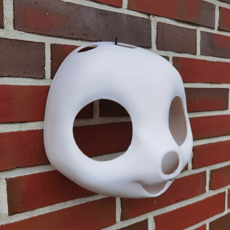 May include: White unfinished mask with large eye and nose holes. The mask is made of a smooth, hard material and is ready to be painted.