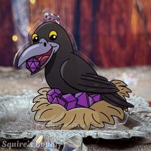 May include: A black crow with yellow eyes holds a purple die in its beak. The crow is sitting in a nest made of straw and purple crystals.