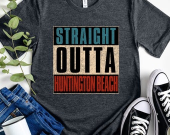 May include: A heather dark grey t-shirt with a vintage-style graphic that reads "STRAIGHT OUTTA HUNTINGTON BEACH".