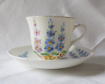 Tuscan White Cup and Saucer,  Blue and Purple Hollyhocks, Flower design, 1930s / 1940s