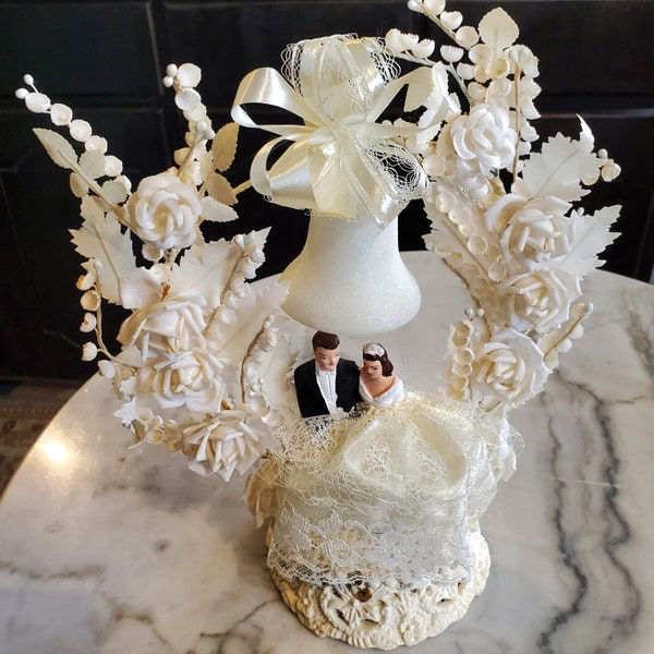 1960s Wedding Cake Topper, Chalkware Bride & Groom On Pedestal With Bell Arch Of Fabric Roses And Lily Of The Valley