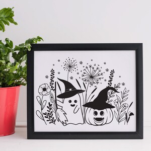 May include: Black and white printable art print featuring a ghost and a pumpkin wearing witch hats in a field of flowers.