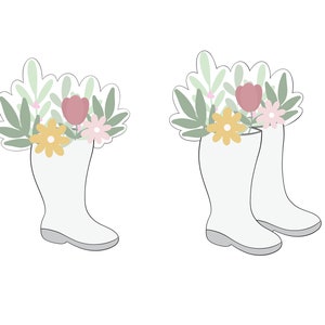 May include: Two white rain boots with green leaves and pink and yellow flowers sticking out of the top.