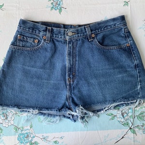 Levi’s Vintage High Waist Cut Off Shorts. Distressed 80s/90s Super High Rise 560 Medium Wash Denim. Size 32 waist. Stringy Daisy Dukes.