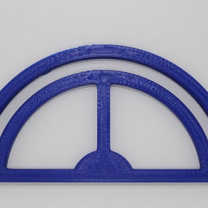 May include: A blue plastic semi-circle shape with a smaller semi-circle shape inside. The shape is a 3D printed design.