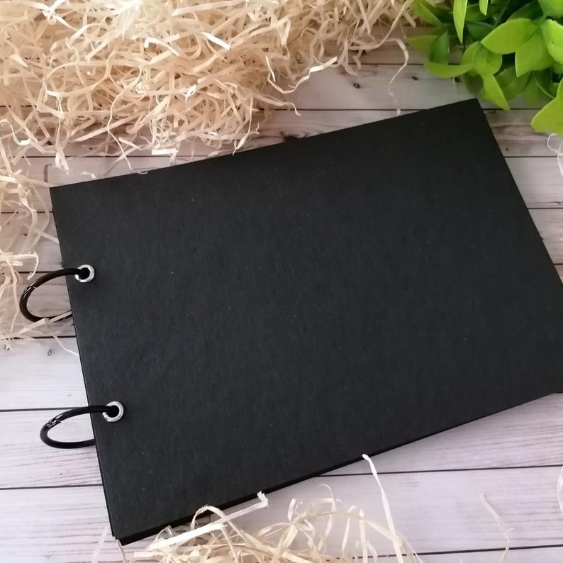 Handmade black photo album with two-ring binding, customizable scrapbook memory book with interior pages available in white or black. Perfect as wedding guest book, baby album, travel keepsake or unique handmade gift.